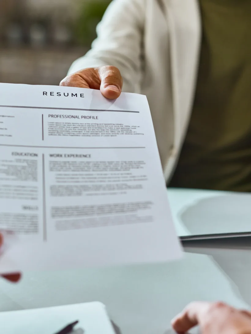 closeup-job-applicant-giving-his-resume-job-interview-office